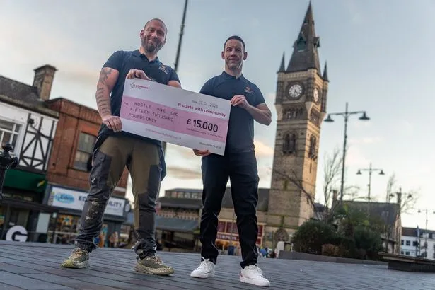 Gavin Copland and Kieron Davis receiving a £15,000 cheque from The National Lottery Community Fund